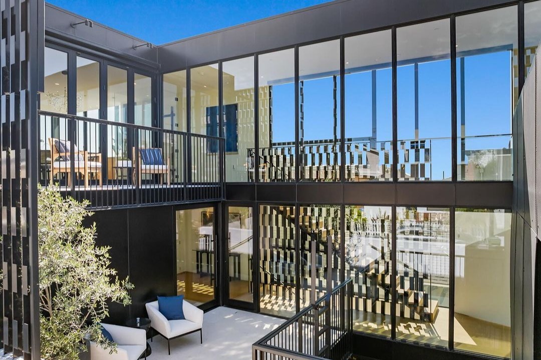 Alma Switch House dining room open to the courtyard through sliding glass